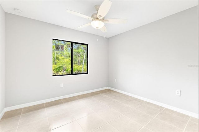 tiled empty room featuring ceiling fan