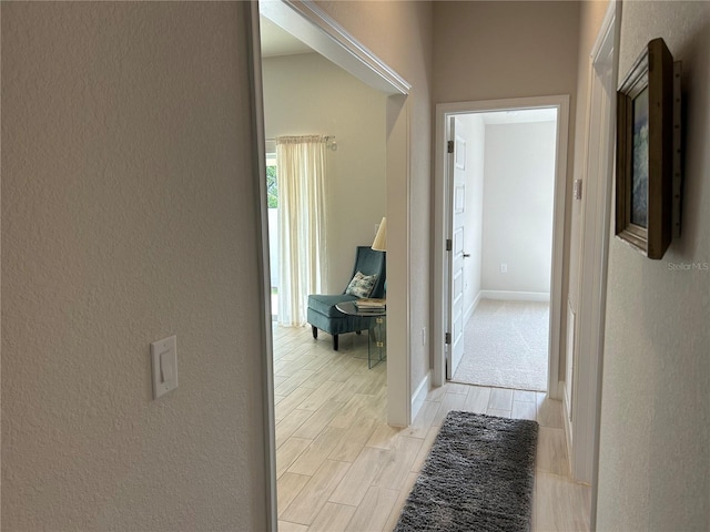 corridor with light hardwood / wood-style flooring