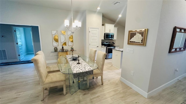 dining room with light hardwood / wood-style flooring, lofted ceiling, and a notable chandelier