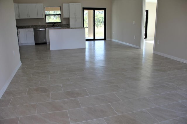 unfurnished living room with tile flooring and sink