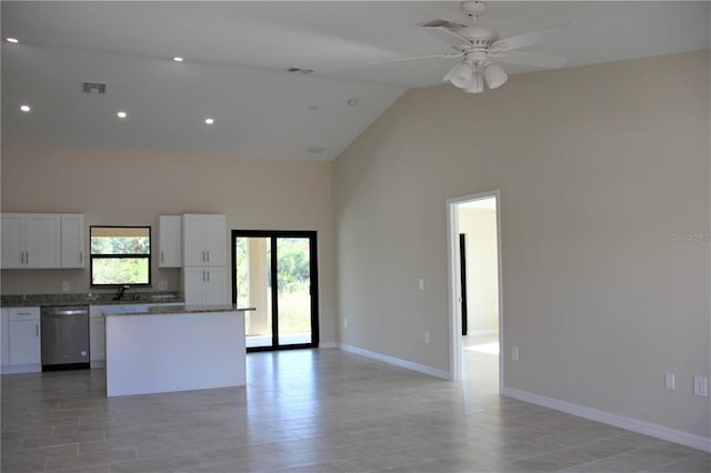 kitchen with ceiling fan, white cabinets, dishwasher, high vaulted ceiling, and a center island