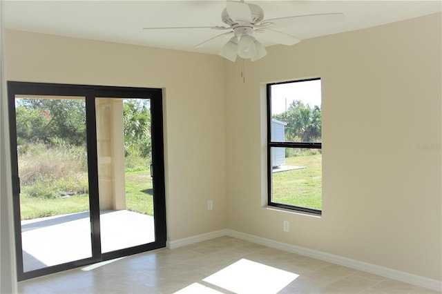 interior space featuring light tile flooring, ceiling fan, and a wealth of natural light