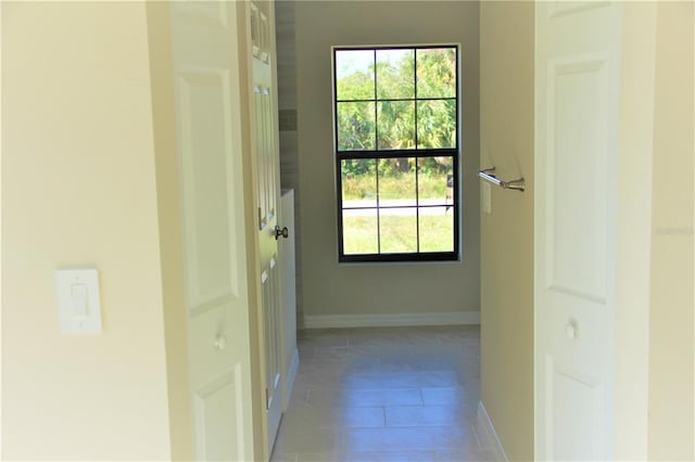 entryway with light tile floors and plenty of natural light