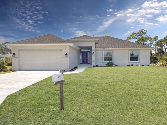 view of front of home with a garage and a front yard