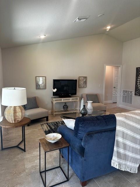 tiled living room with lofted ceiling