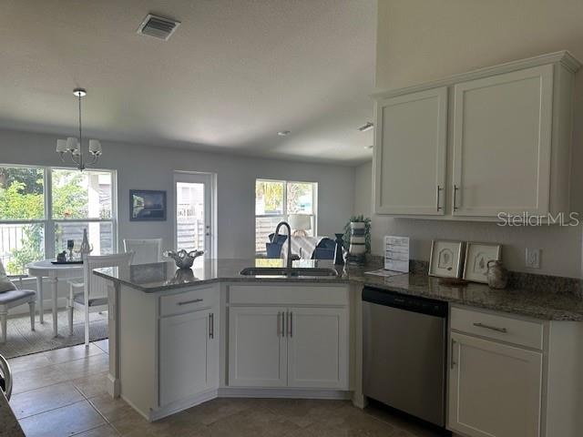 kitchen featuring a notable chandelier, visible vents, white cabinets, a sink, and dishwasher