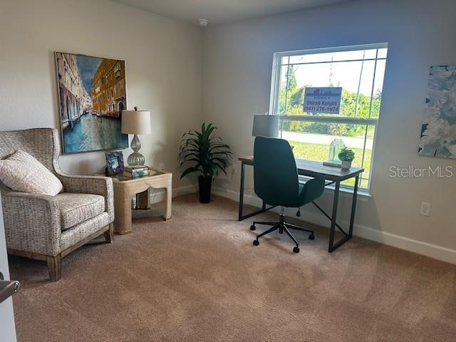 carpeted office featuring baseboards