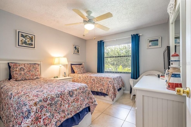 tiled bedroom featuring ceiling fan and a textured ceiling