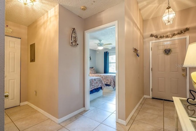 tiled entrance foyer with a textured ceiling