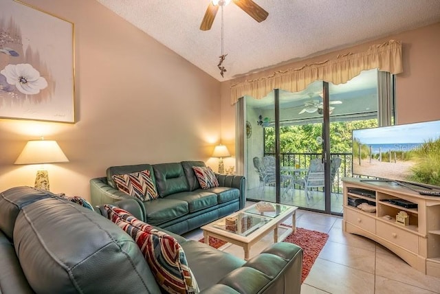 tiled living room with lofted ceiling, a textured ceiling, and ceiling fan