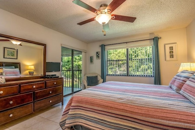 tiled bedroom with ceiling fan, a textured ceiling, and access to outside