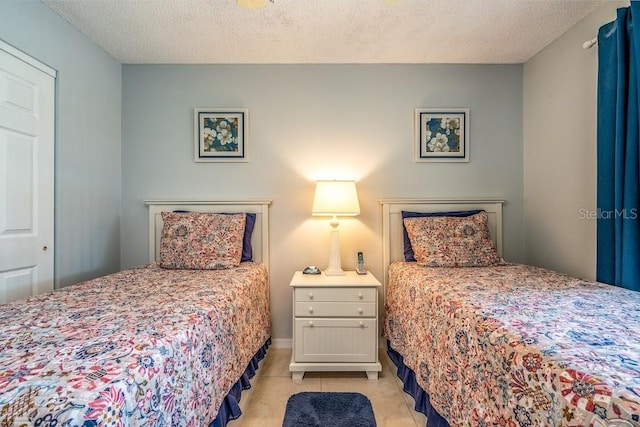 tiled bedroom with a textured ceiling