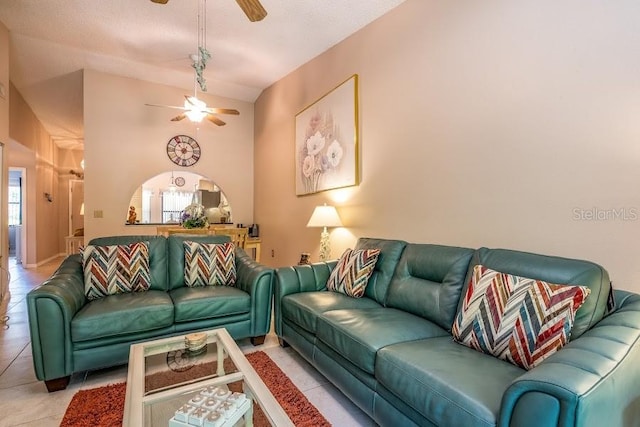 living room featuring light tile patterned floors, high vaulted ceiling, and ceiling fan