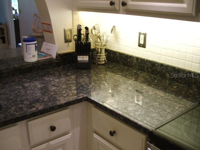 interior space with dark stone countertops