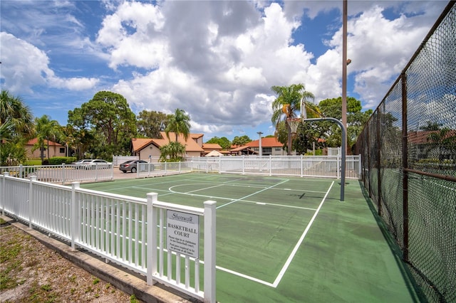 view of basketball court featuring tennis court