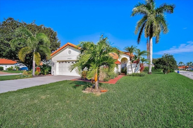 mediterranean / spanish home with a garage and a front lawn