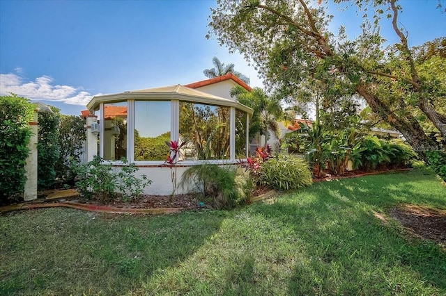 view of side of property with a lawn