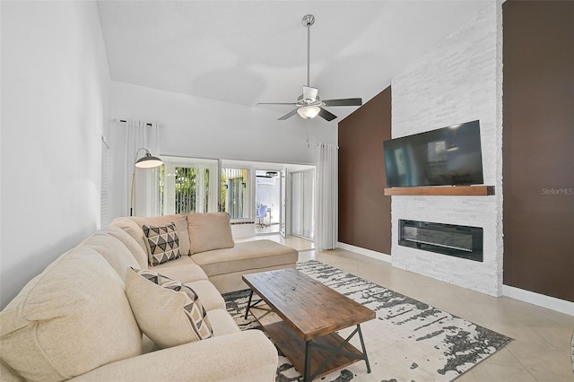 living room featuring ceiling fan, light tile patterned floors, a fireplace, and high vaulted ceiling