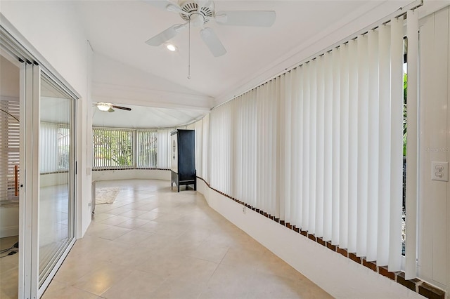 hallway with lofted ceiling and light tile patterned floors