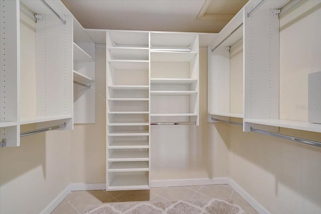 spacious closet with light tile patterned flooring