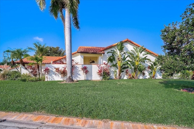 mediterranean / spanish-style house featuring a front lawn