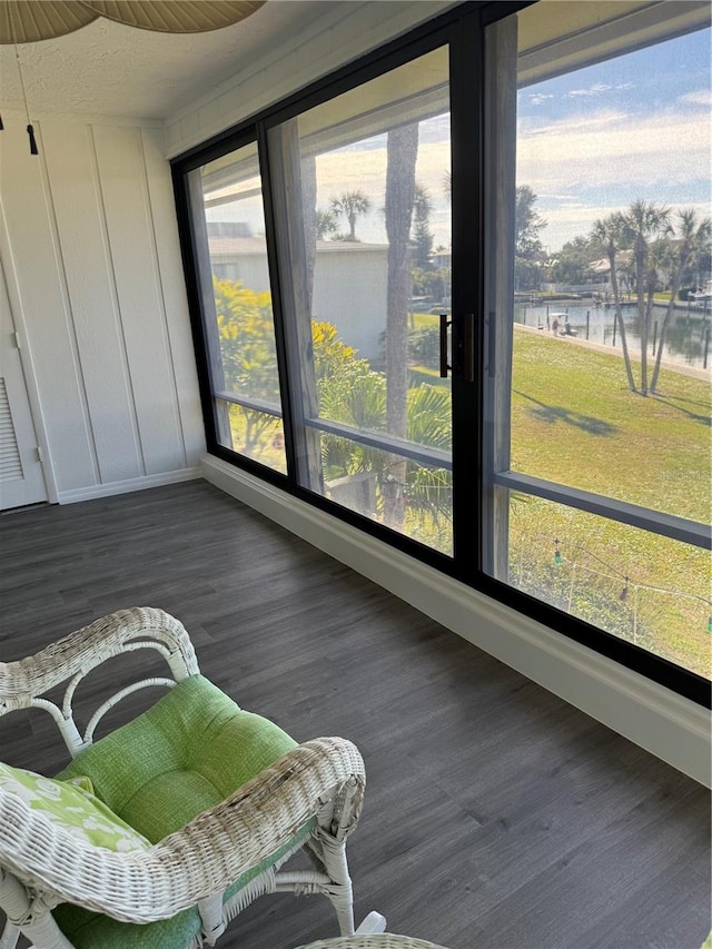 sunroom / solarium with a water view and plenty of natural light