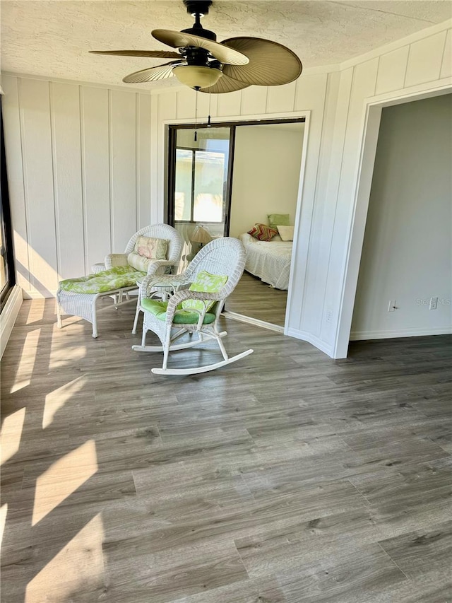 interior space featuring a textured ceiling, hardwood / wood-style flooring, and ceiling fan