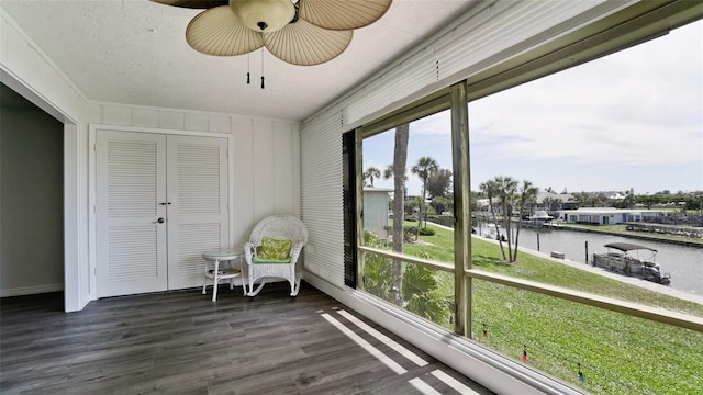 unfurnished sunroom featuring a water view