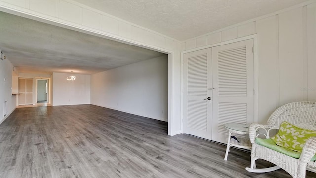 sitting room with wood-type flooring and a textured ceiling