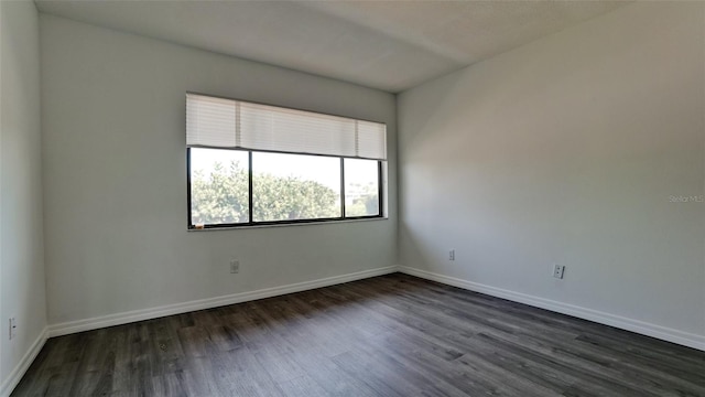 unfurnished room featuring dark wood-type flooring