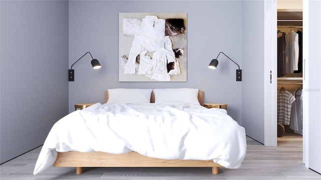 bedroom with light wood-type flooring and a closet