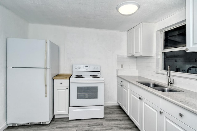 kitchen with light hardwood / wood-style flooring, white appliances, white cabinetry, and sink