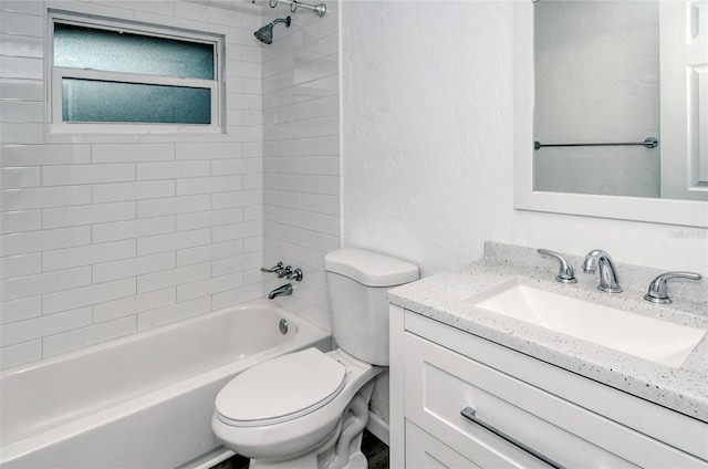 full bathroom featuring toilet, tiled shower / bath combo, and vanity