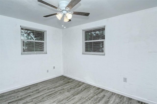 unfurnished room featuring hardwood / wood-style floors and ceiling fan