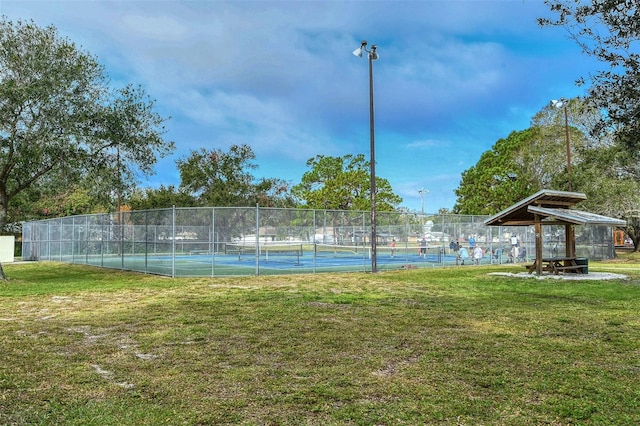 view of sport court with a yard