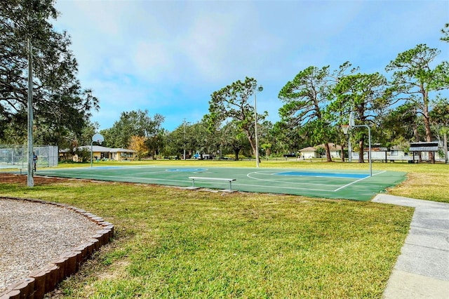 view of home's community with a yard and basketball court