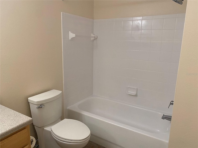 full bathroom featuring tiled shower / bath combo, toilet, and vanity