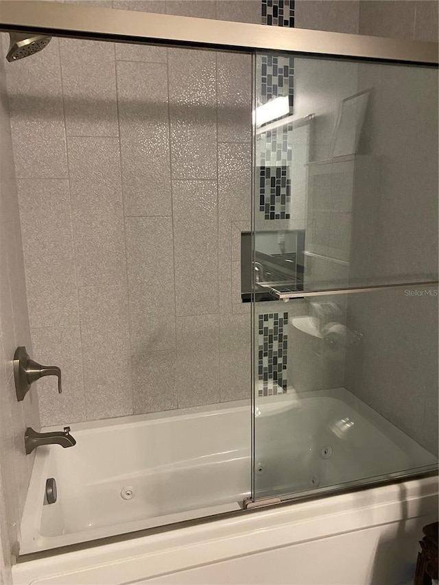 bathroom with shower / bath combination with glass door