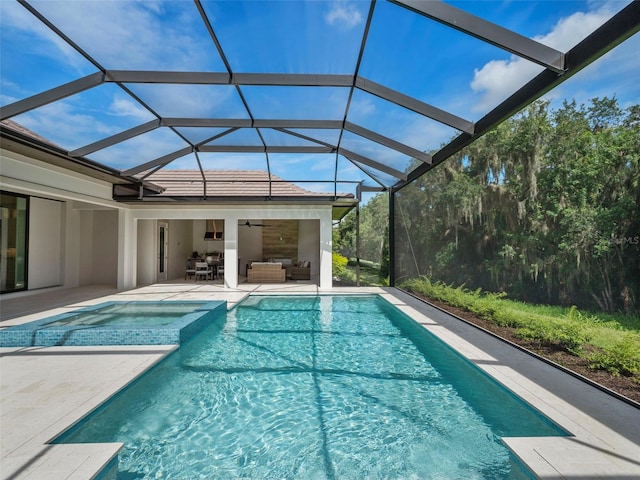 view of pool featuring an outdoor living space, a lanai, a patio, and ceiling fan