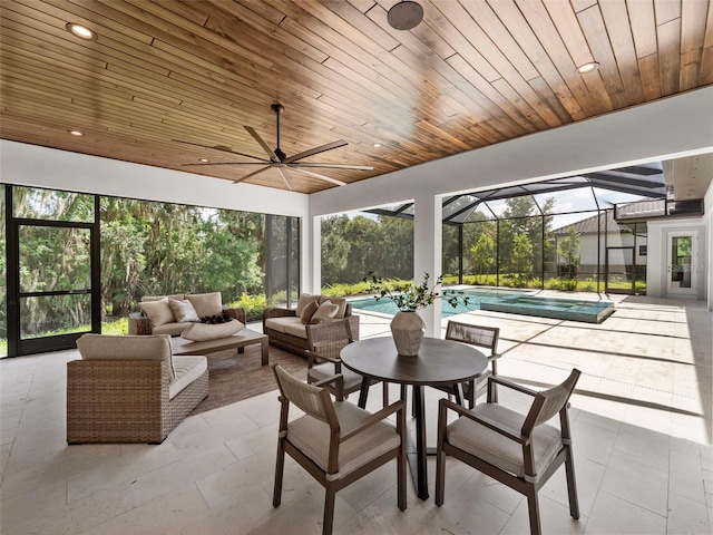 sunroom with ceiling fan and wooden ceiling