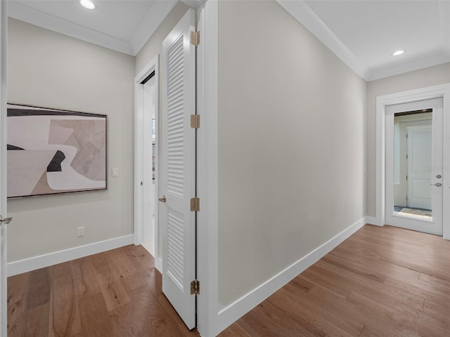 corridor with crown molding and light wood-type flooring