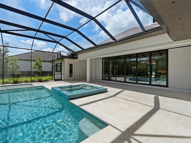 view of pool with an in ground hot tub, a patio, and glass enclosure