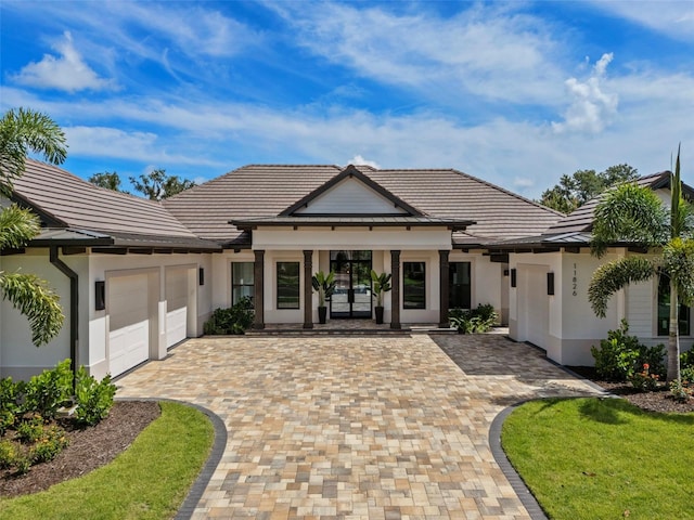 view of front of home with a porch and a garage