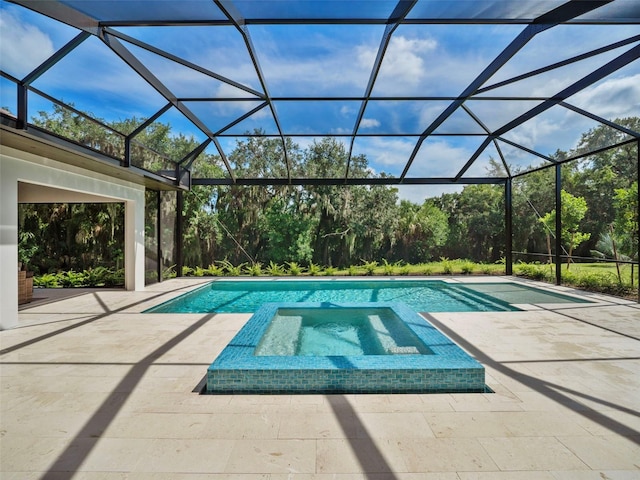 view of pool with a patio and glass enclosure