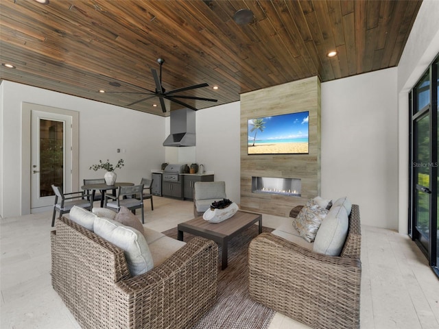 living room with wood ceiling, a large fireplace, and ceiling fan