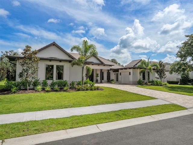 view of front of property featuring a garage and a front lawn