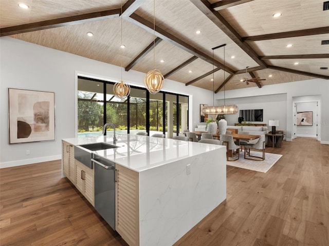 kitchen featuring a spacious island, dishwasher, hardwood / wood-style floors, and pendant lighting