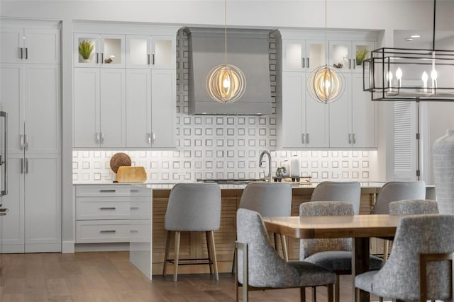 kitchen with white cabinetry, pendant lighting, dark hardwood / wood-style flooring, and decorative backsplash