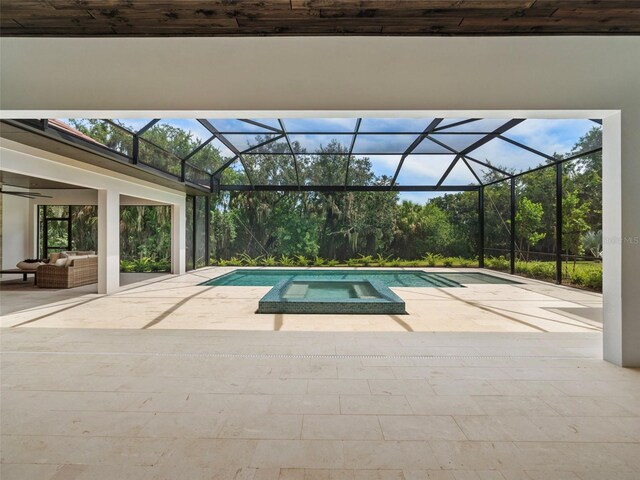 view of swimming pool with an outdoor hangout area, a patio area, and glass enclosure