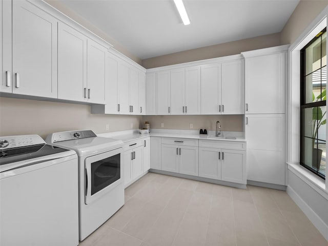 laundry room with cabinets, sink, and independent washer and dryer